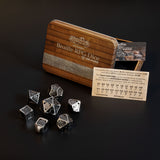7 piece set of hollow metal braille rpg dice in silver ingot with metal case and sighted braille guide.