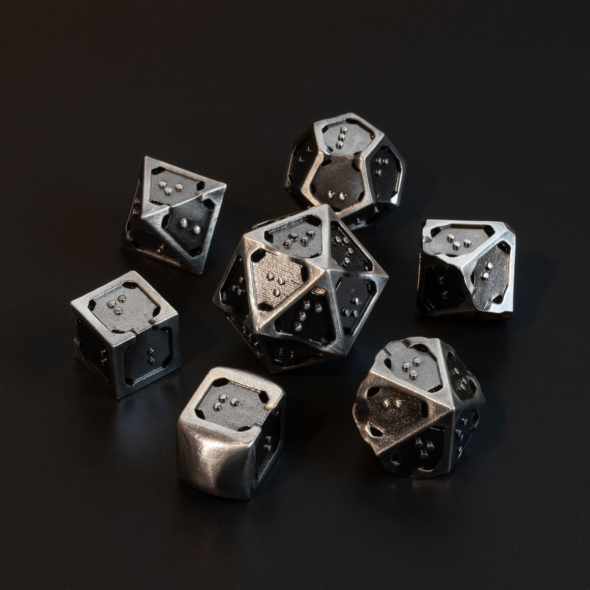 7 piece set of hollow metal braille rpg dice in silver ingot