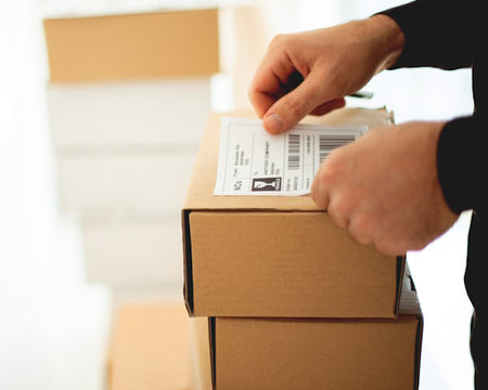 Shipping labels being applied to boxes.